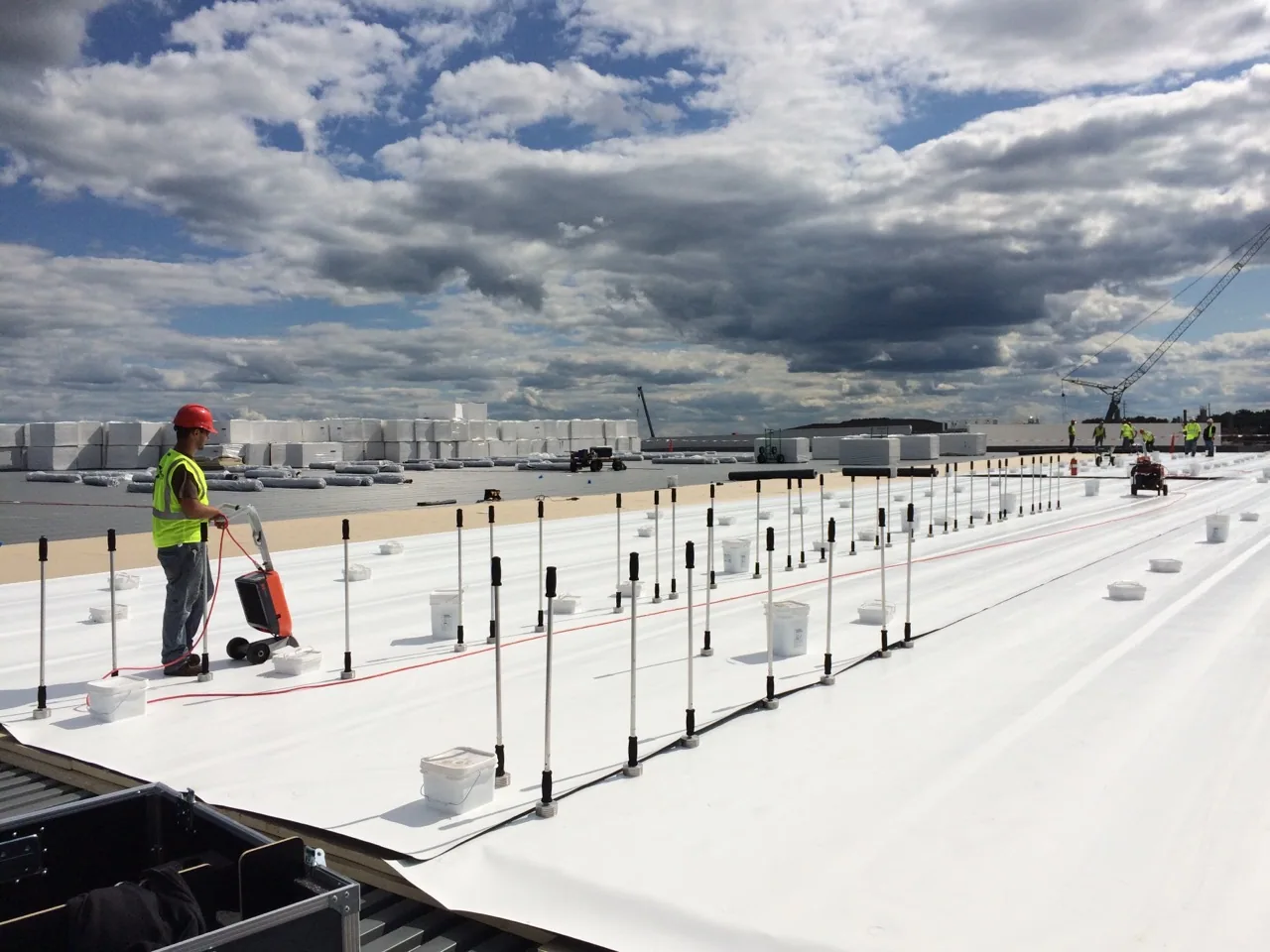Crew installing a white membrane roof